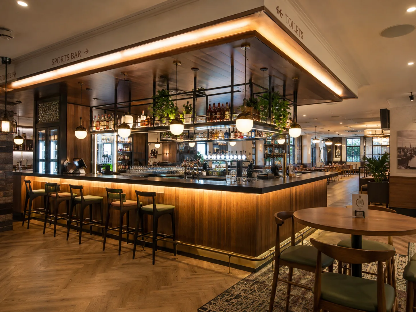 Completed tavern interior Sydney with open plan layout, custom joinery bar, feature lighting design and warm commercial hospitality atmosphere